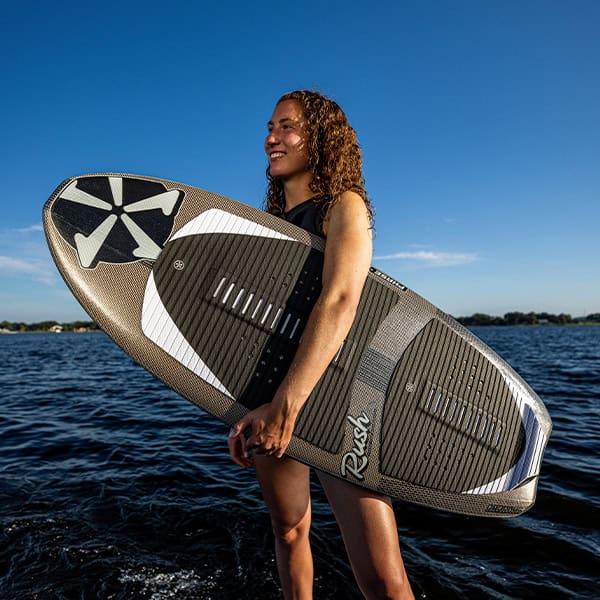 Surfboard with a woman standing on water, sunny day, outdoor water sports scene, active lifestyle, water adventure gear, summer fun, beach activity, water sports equipment, outdoor recreation, leisure activity